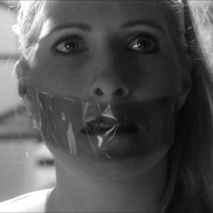 A woman is kidnapped taped to a chair and tape gagged in Plak Band Short Film - Thumbnail
